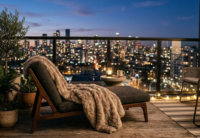 Editorial hero shot of a luxury five-foot apartment balcony at twilight, featuring 2700K warm glow lighting and plush faux-mohair throws.
