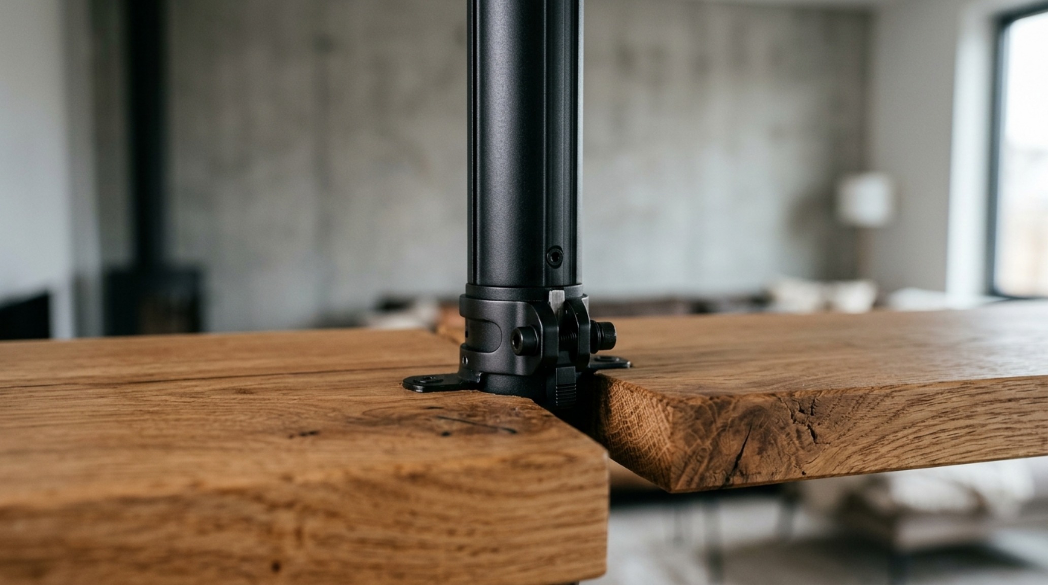 Detailed close-up of a matte charcoal tension pole mast and a light wood shelf, showing the engineering of no-drill wall shelves that mimic permanent architecture. Detailed close-up of a matte charcoal tension pole mast and a light wood shelf, showing the engineering of no-drill wall shelves that mimic permanent architecture.