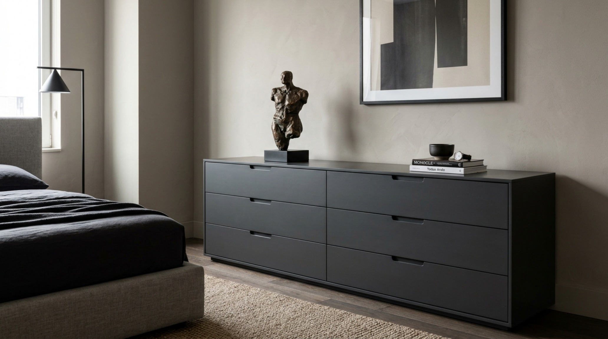 Minimalist dresser for bachelors in a deep slate charcoal finish with handle-less push-to-open drawers and a long, low architectural profile. Minimalist dresser for bachelors in a deep slate charcoal finish with handle-less push-to-open drawers and a long, low architectural profile.