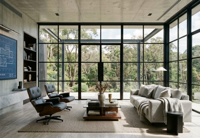 steel and glass home blueprints featuring ultra-slim Crittall-style matte black frames in a sun-drenched living area with honed travertine floors
