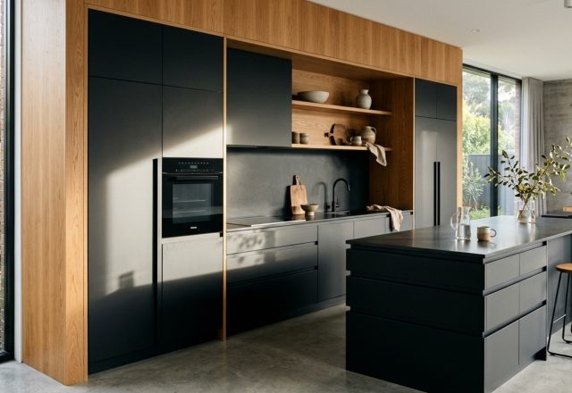 integrated handleless cabinetry featuring a minimalist J-pull profile in matte black with seamless alignment and natural oak accents