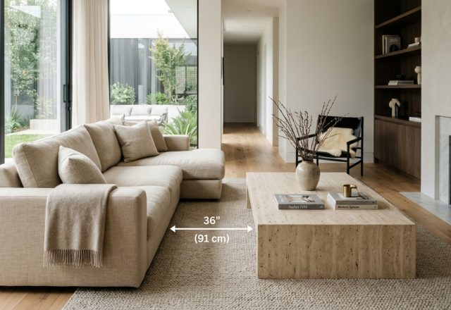 Ergonomic furniture placement 3d demonstrating a 36-inch primary walkway around a custom linen sectional with a 18-inch clearance to a honed travertine coffee table.