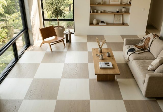 High-angle view of a minimalist living room with painting floors decor ideas featuring a soft cream checkerboard pattern on original pine planks.