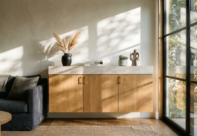 modern ikea room design ideas featuring a floating media console in rift-sawn oak with a honed travertine top and 2700K integrated LED lighting.