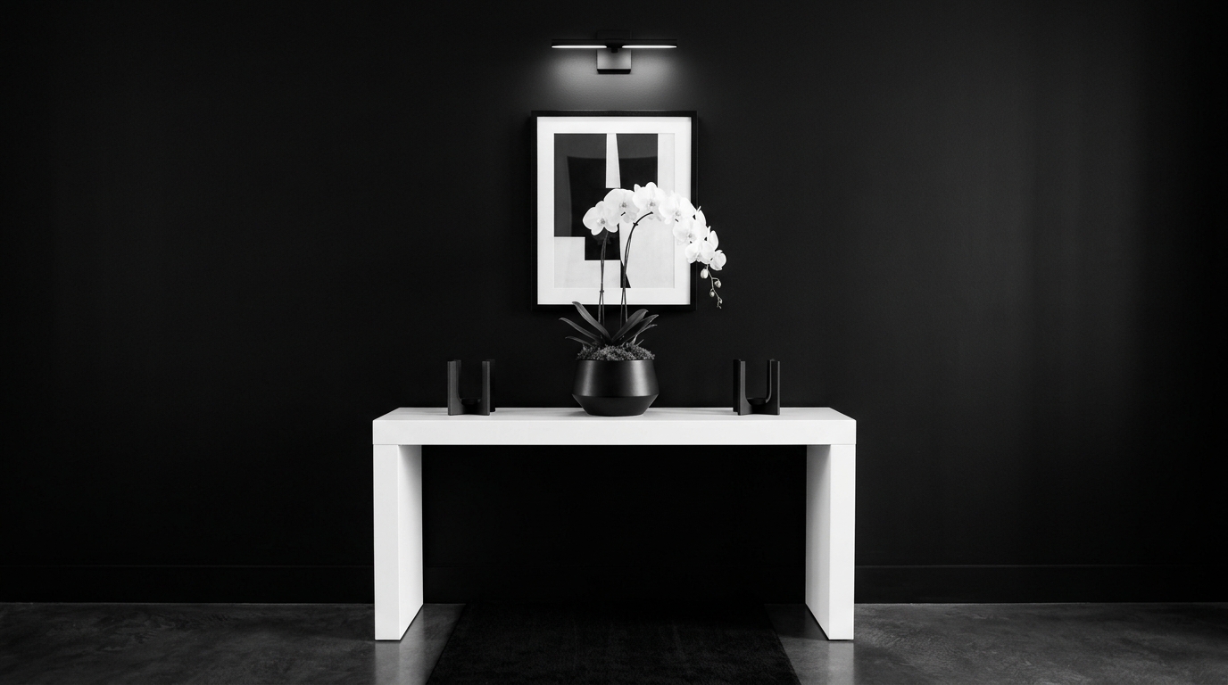 Monochromatic entryway with a white console, white walls, and black hardware for sharp contrast.