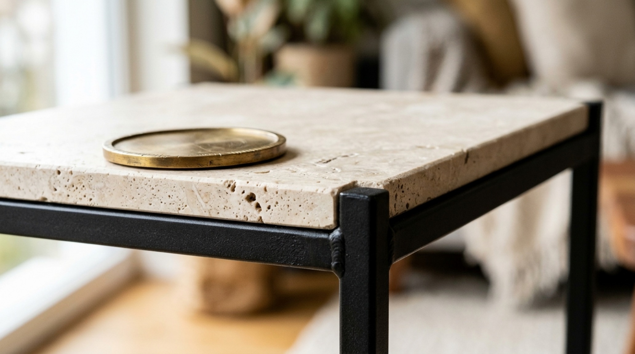Close-up of a custom ikea vittsjoe side table for small decor ideas hack showing a honed travertine top replacing the standard glass.