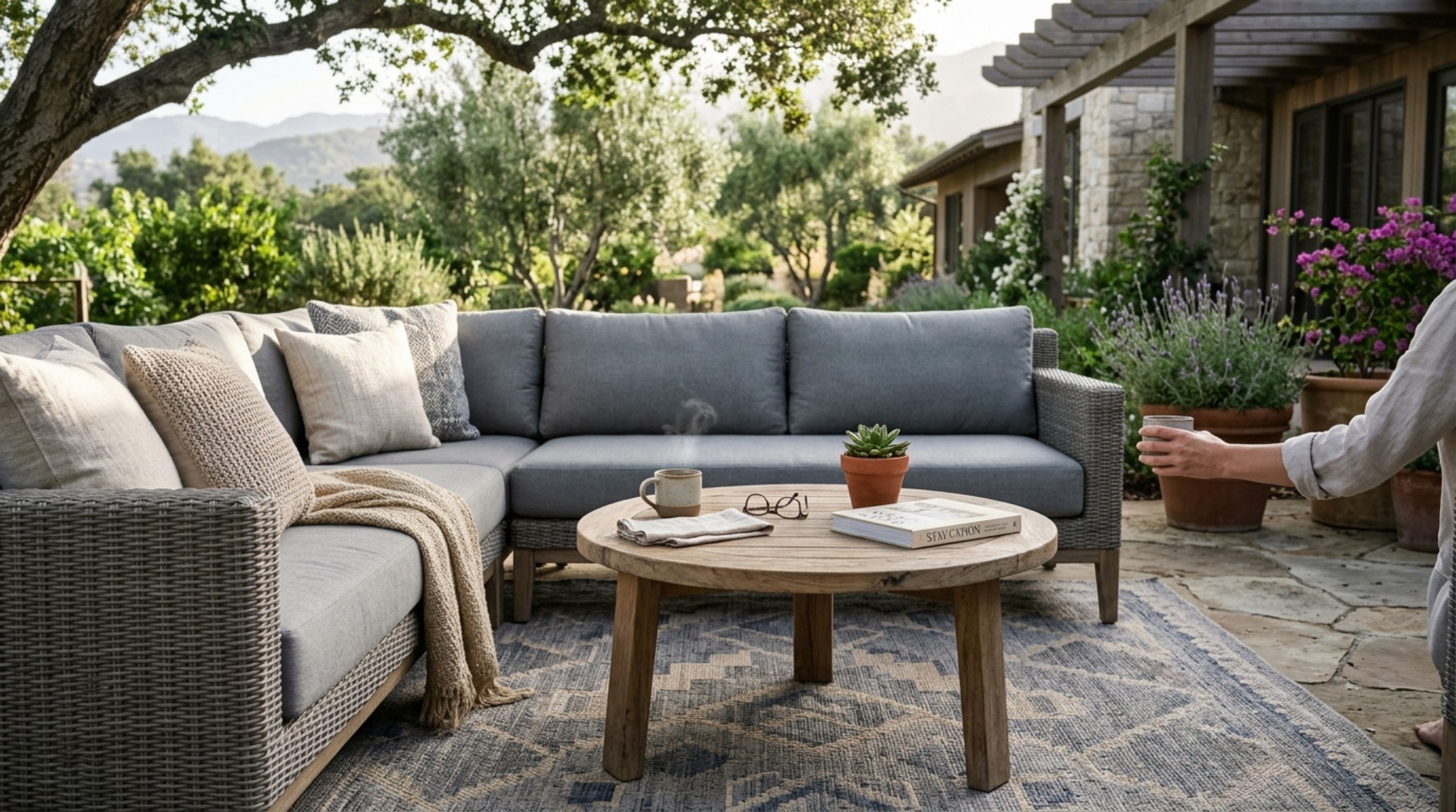 Close-up of a curated lounge area within a gazebo showing 18-inch clearance between a woven coffee table and a gray performance linen sectional sofa. Close-up of a curated lounge area within a gazebo showing 18-inch clearance between a woven coffee table and a gray performance linen sectional sofa.