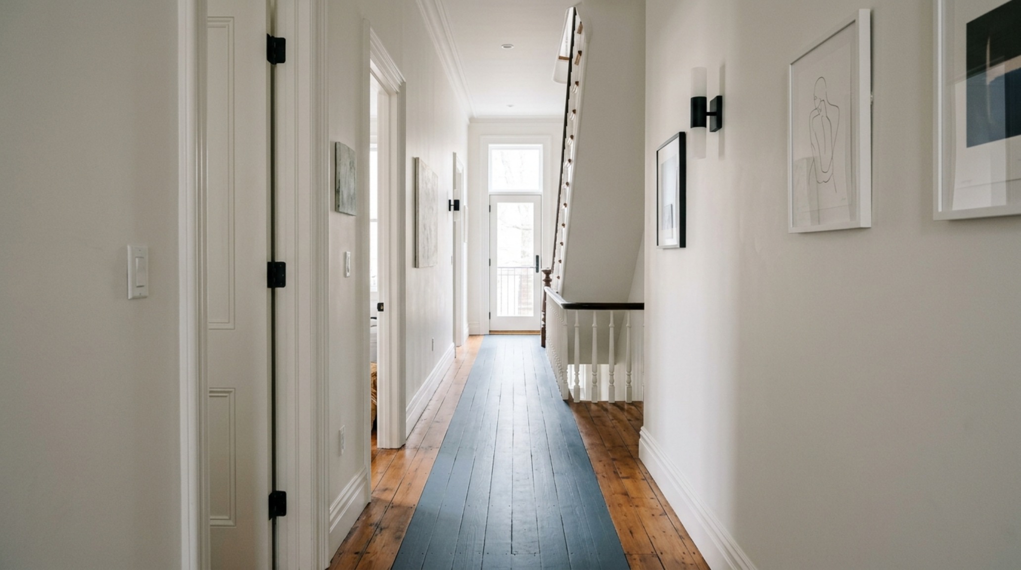 A narrow Victorian hallway utilizing painting floors decor ideas layout to create a visual runner with 36-inch clearance.
