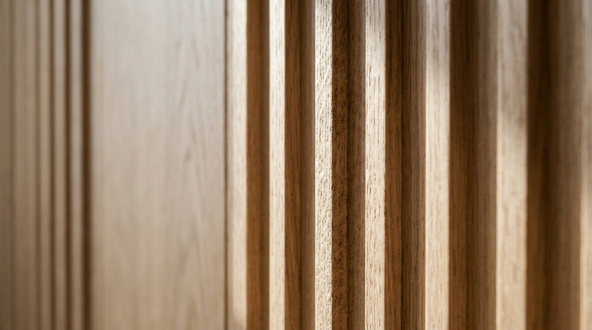 Close-up of bespoke fluted oak millwork hiding household storage, illustrating the architectural integration and decluttering hacks of Wallander's home.