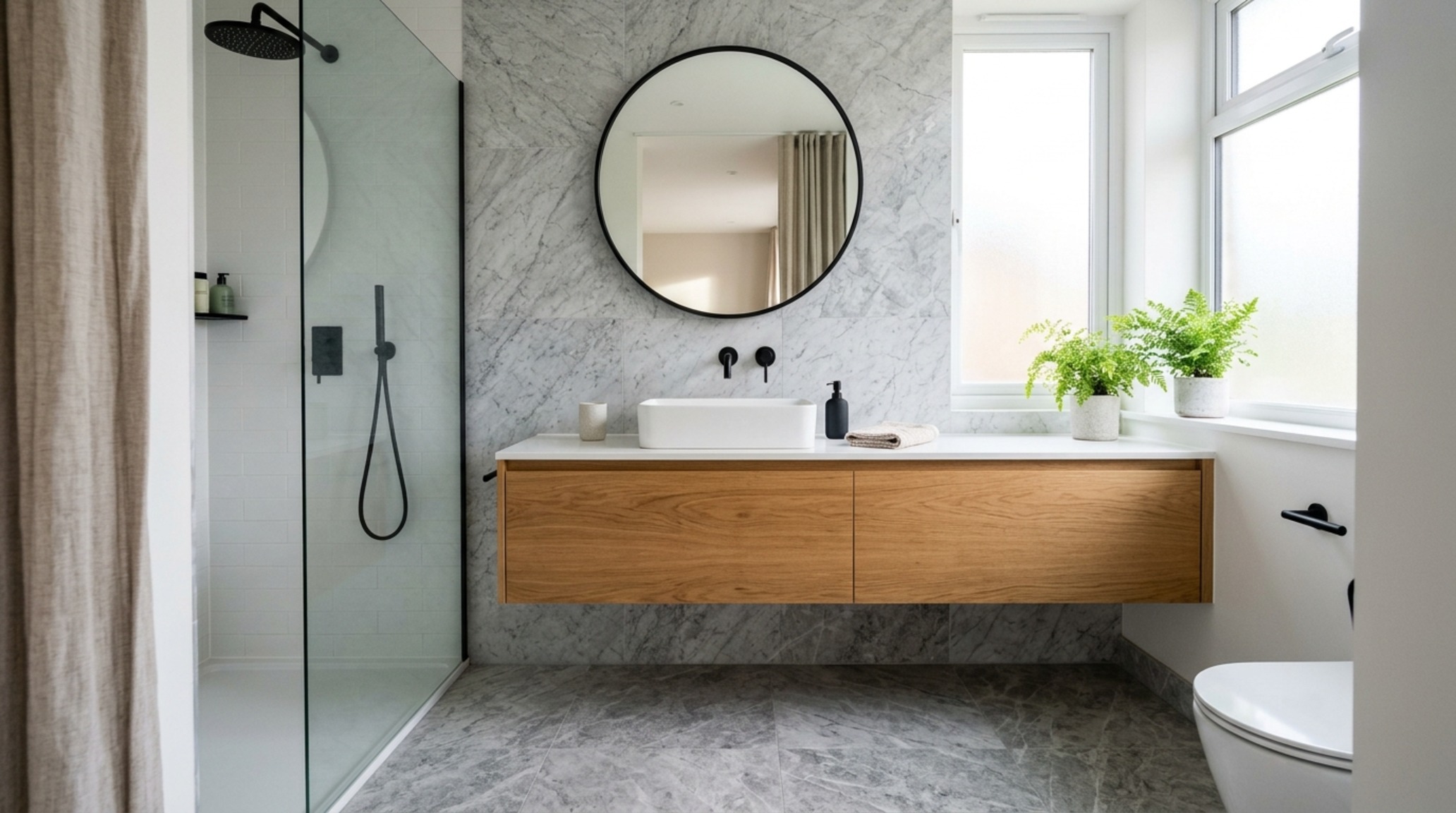 small space interior design advice showing a wall-mounted floating vanity in a compact bathroom with floor-to-ceiling porcelain tiles and aged brass fixtures