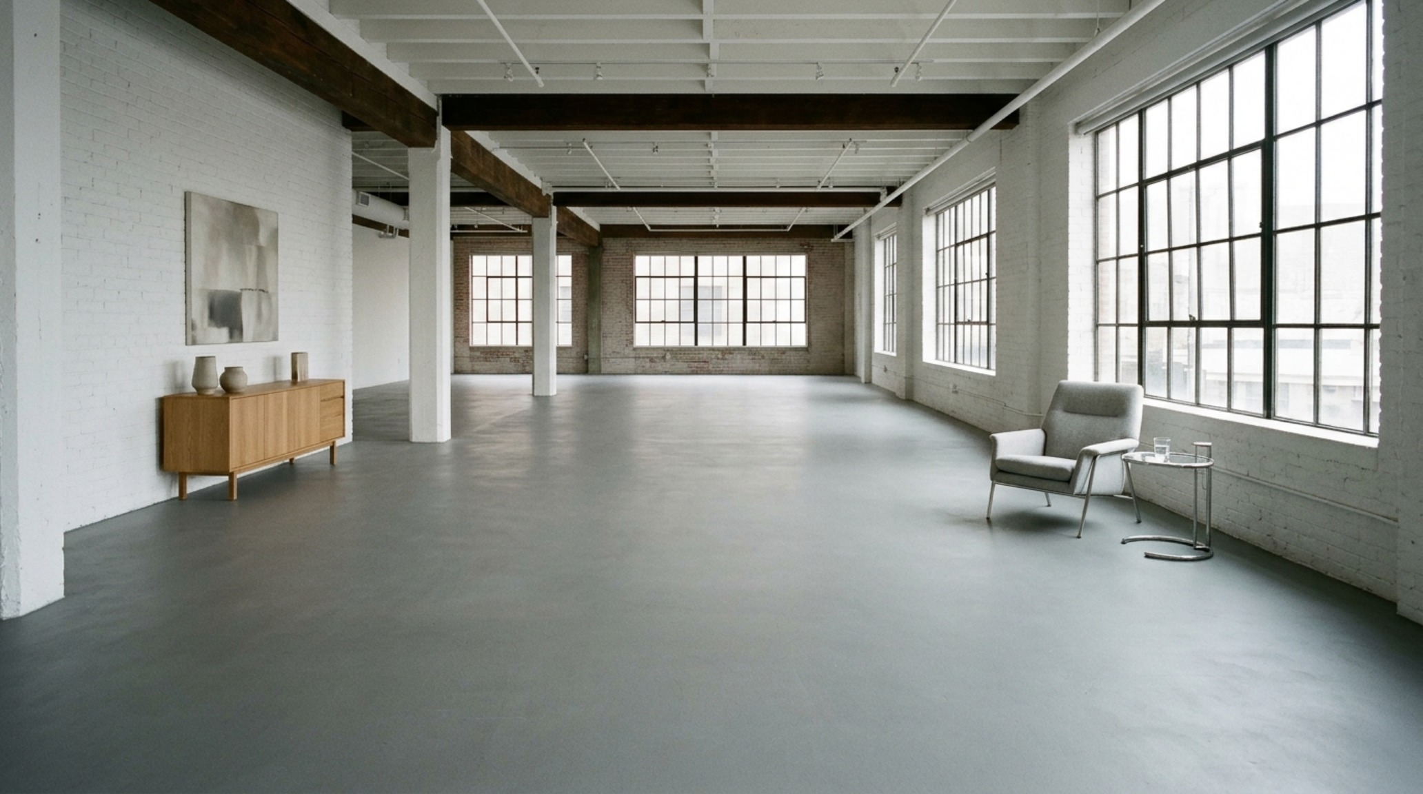 Perspective shot of a loft space with a monolithic sage green painted floor, showing high CRI lighting and negative space.