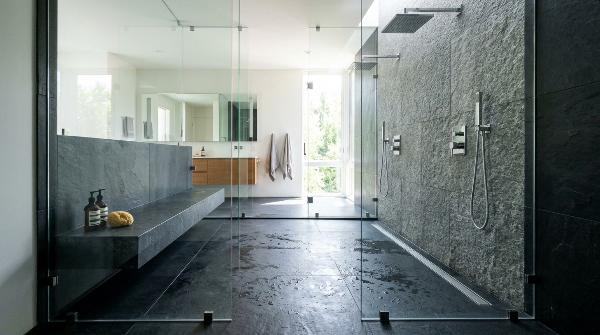 Curbless wet room design guide featuring a large-format slate tile floor and a frameless glass partition for an open-concept feel. Curbless wet room design guide featuring a large-format slate tile floor and a frameless glass partition for an open-concept feel.