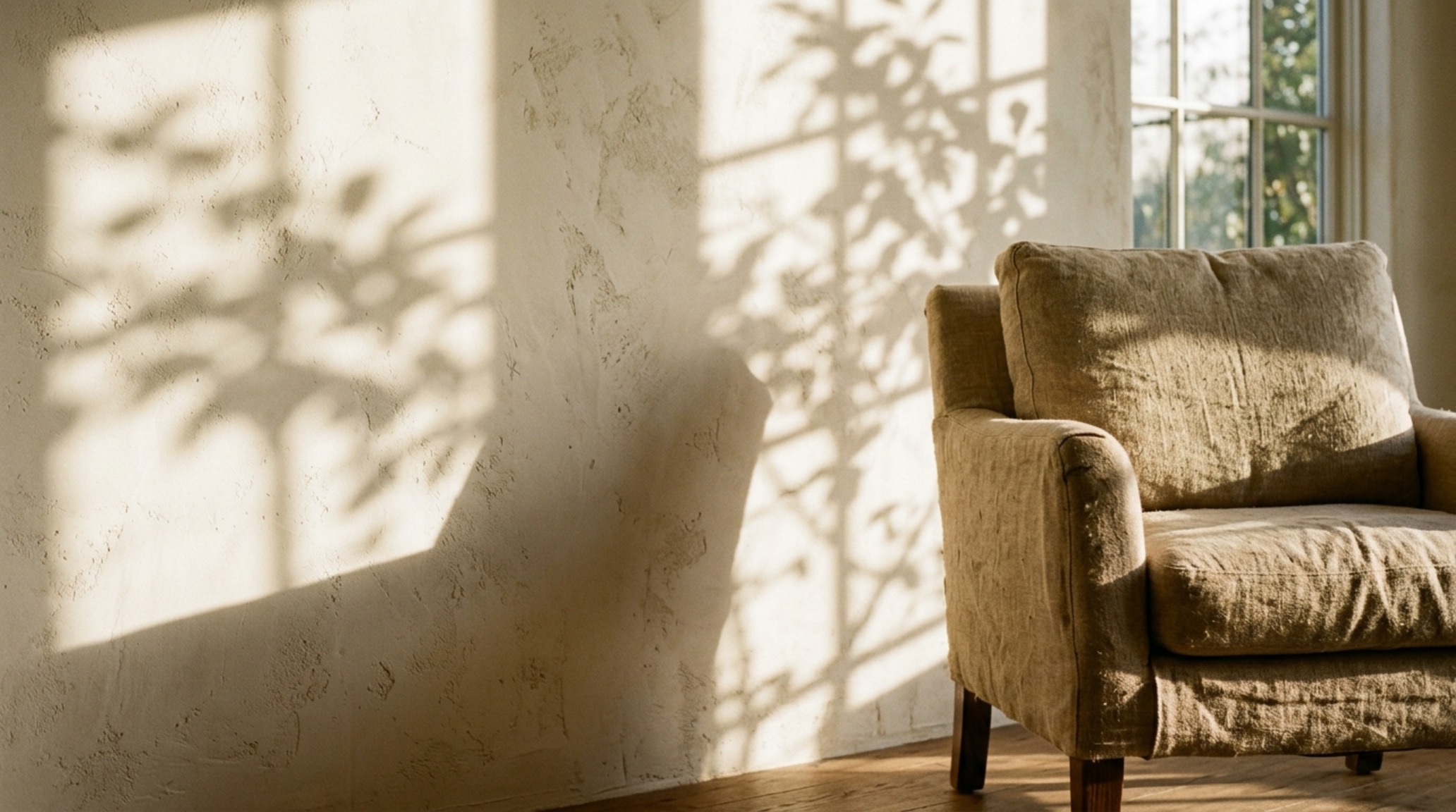 luxury home interior blogs textures featuring raw Belgian linen upholstery and hand-applied plaster walls with subtle shadow play