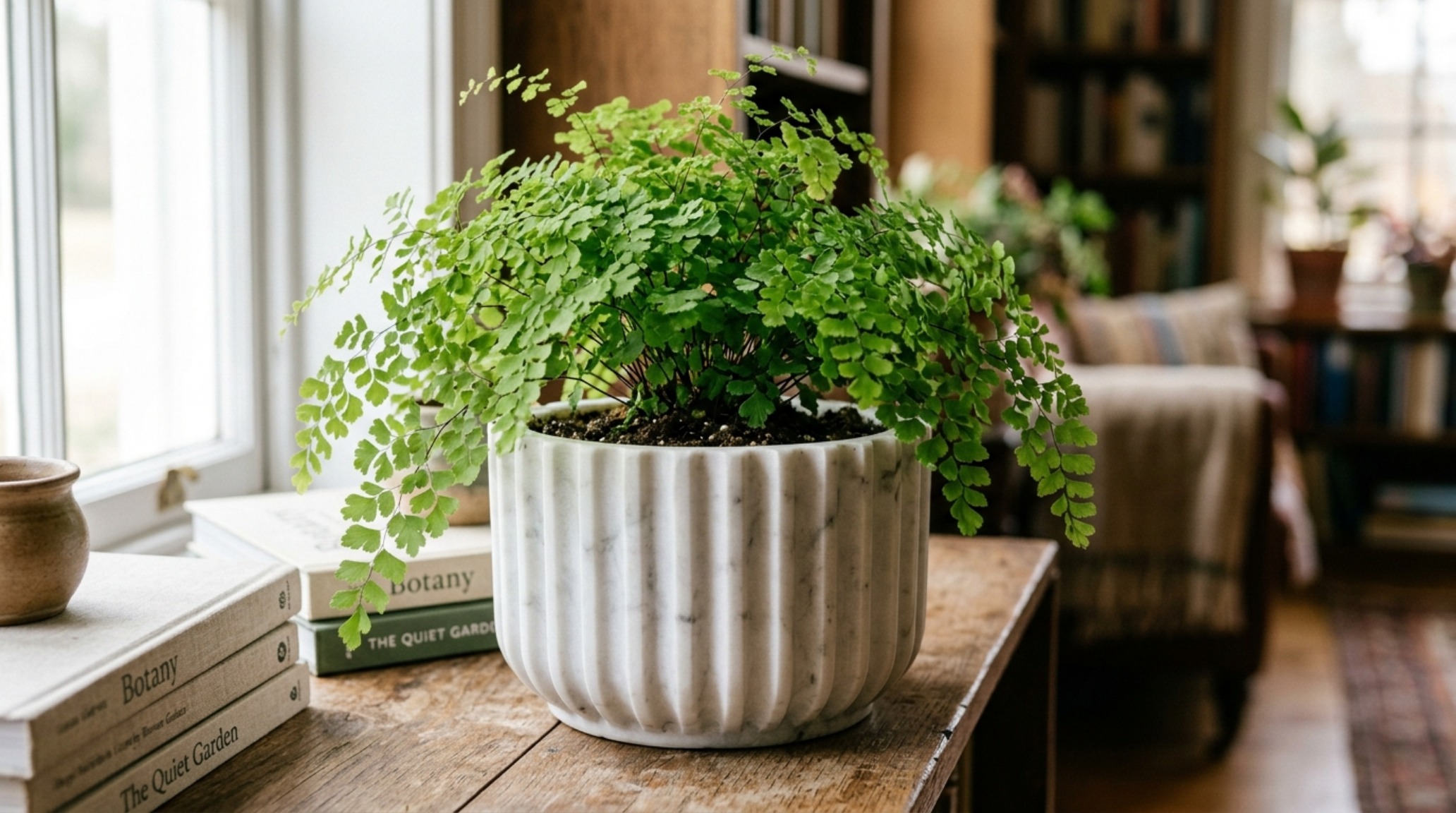 luxury indoor plant decoration ideas textures showcasing a fluted marble planter housing a delicate Maidenhair Fern