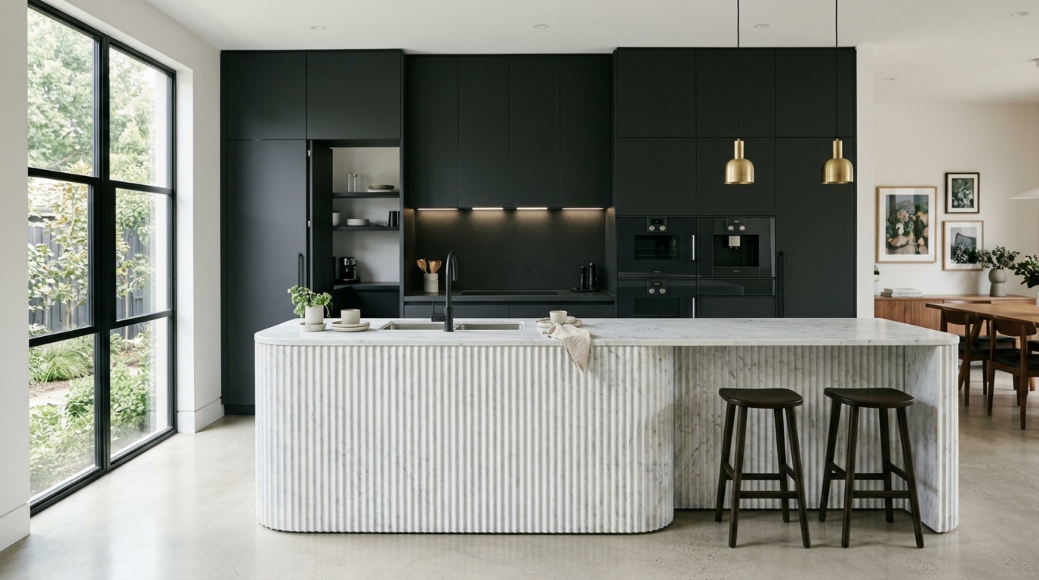 residential interior architecture trends highlighting an open-concept kitchen with a fluted stone island and hidden appliance storage for a clean silhouette residential interior architecture trends highlighting an open-concept kitchen with a fluted stone island and hidden appliance storage for a clean silhouette