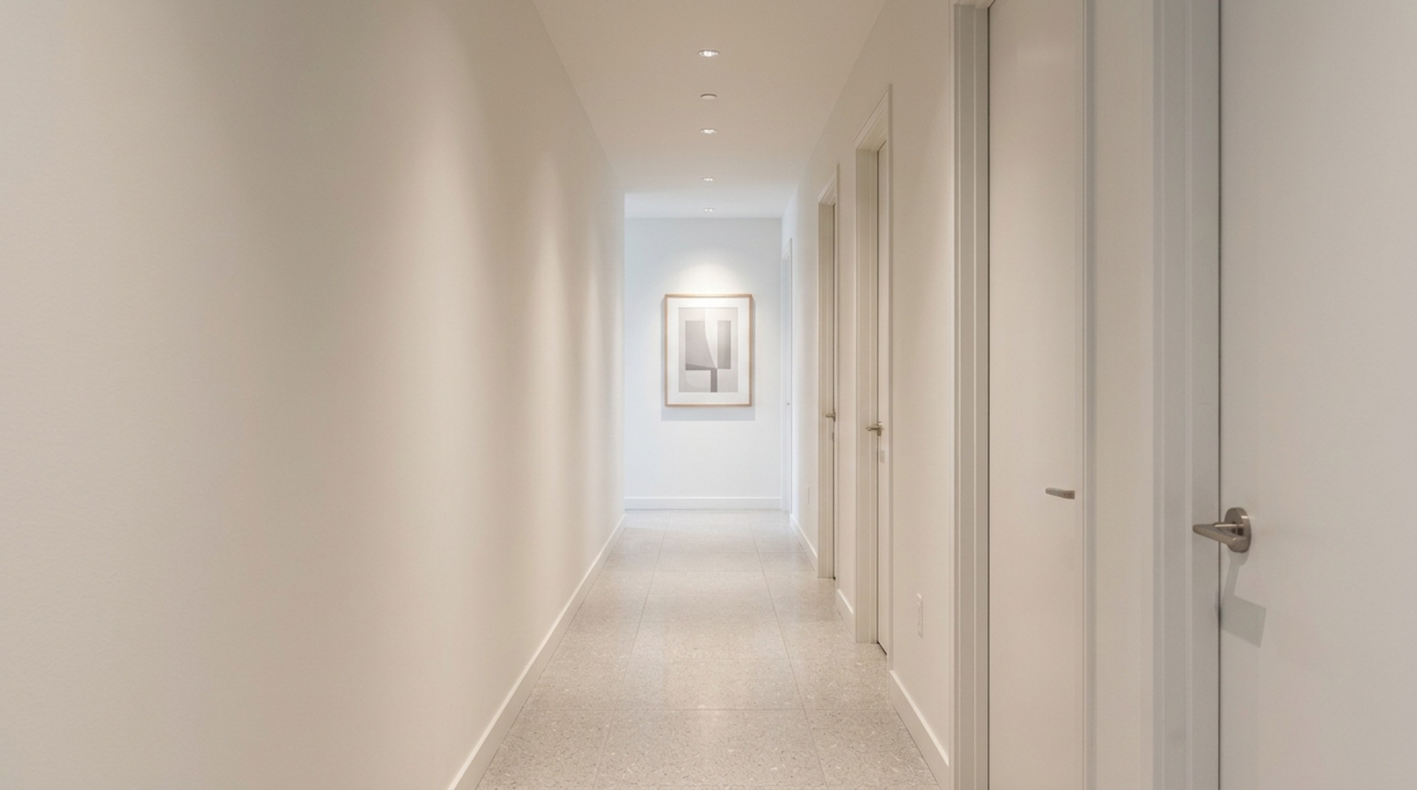 Perspective view of a long hallway with 36-inch clearance, showcasing sightline alignment and the use of warm 2700K ambient lighting to create spatial flow. Perspective view of a long hallway with 36-inch clearance, showcasing sightline alignment and the use of warm 2700K ambient lighting to create spatial flow.