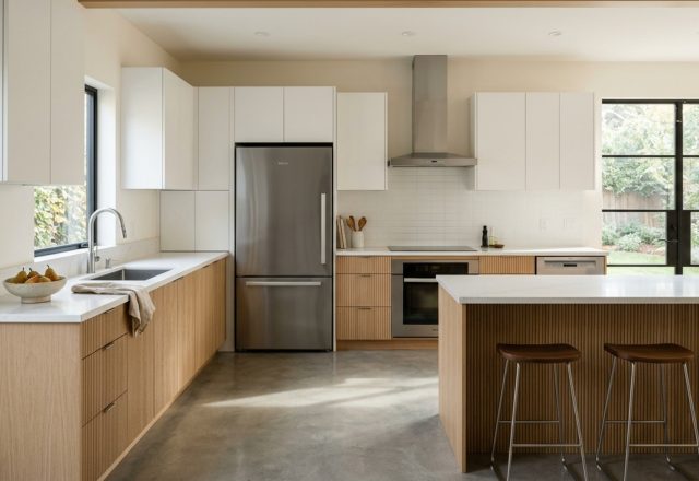 kitchen work triangle optimization visualized in a high-end L-shaped kitchen featuring a Wolf range and Sub-Zero refrigerator with 42-inch clear aisles.