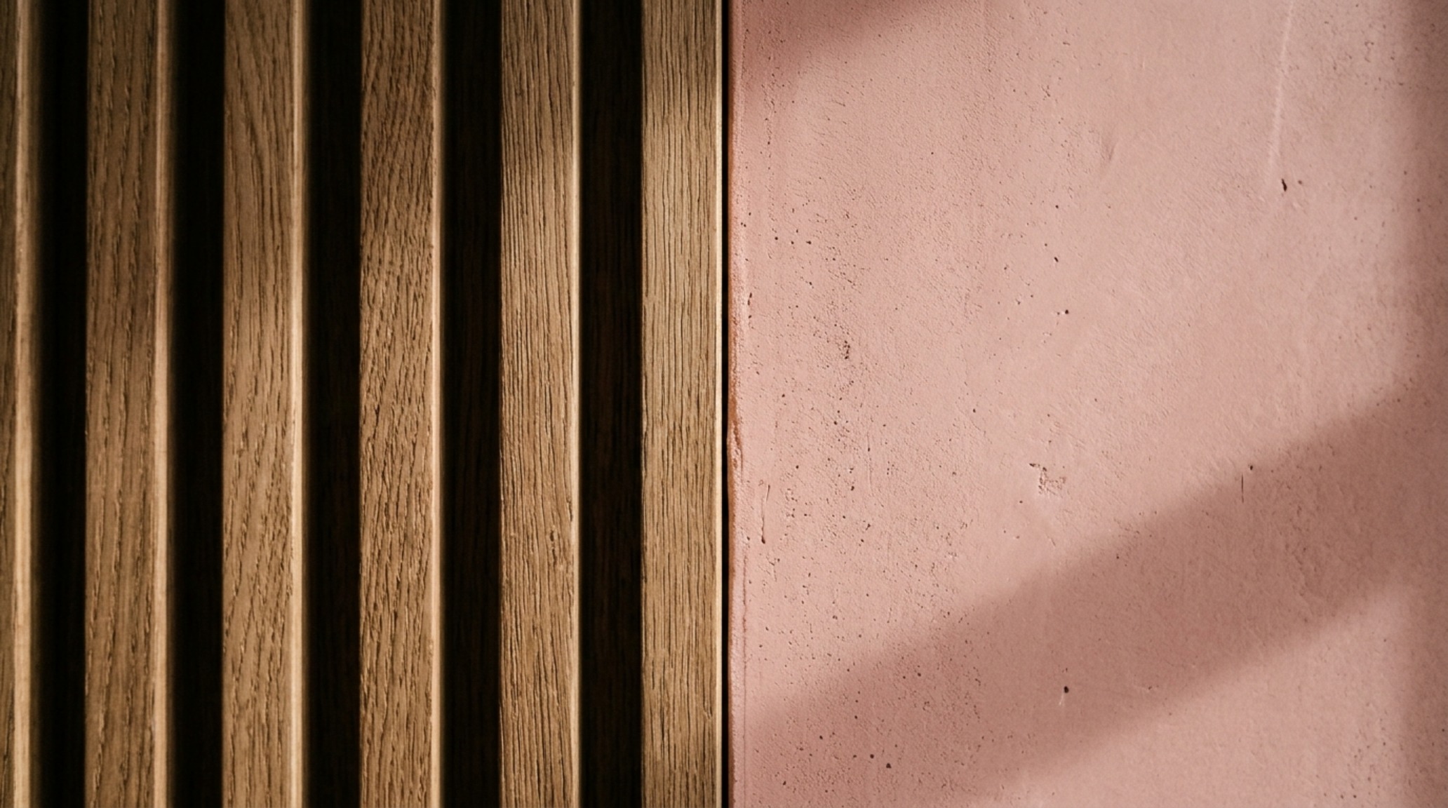 Close-up of a fluted white oak cabinet handle against a Setting Plaster wall, illustrating luxury most beautiful islands world decor ideas textures.