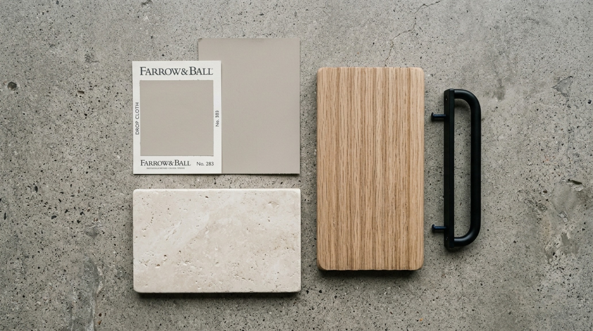 A flat-lay of design materials including Benjamin Moore Pale Oak swatches, a piece of honed travertine, and a sample of fluted white oak for a modern farmhouse exterior.