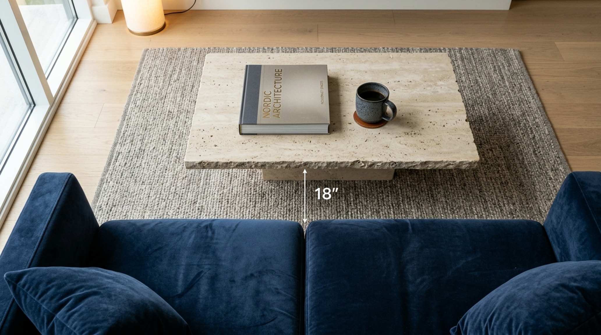 Modern living room decor essentials displaying 18-inch reach spacing from a velvet sectional to a minimalist circular tray.