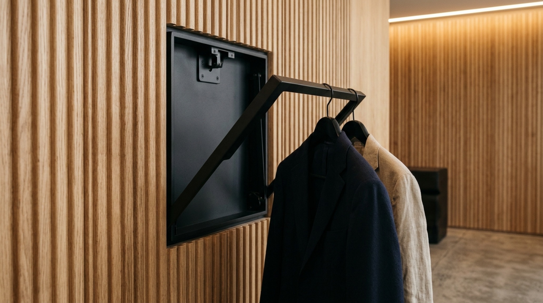 fold up clothes hanger integrated into custom white oak cabinetry with a 36-inch walkway clearance