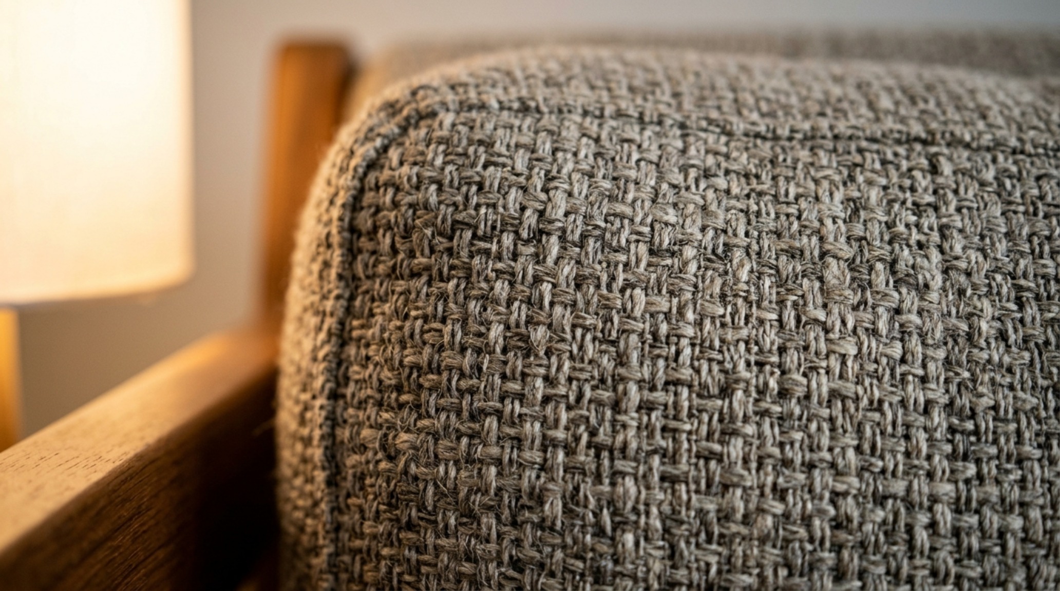 Nighttime atmospheric lighting with a 3000K task lamp highlighting the fabric weave and texture of a modern sofa bed. Nighttime atmospheric lighting with a 3000K task lamp highlighting the fabric weave and texture of a modern sofa bed.