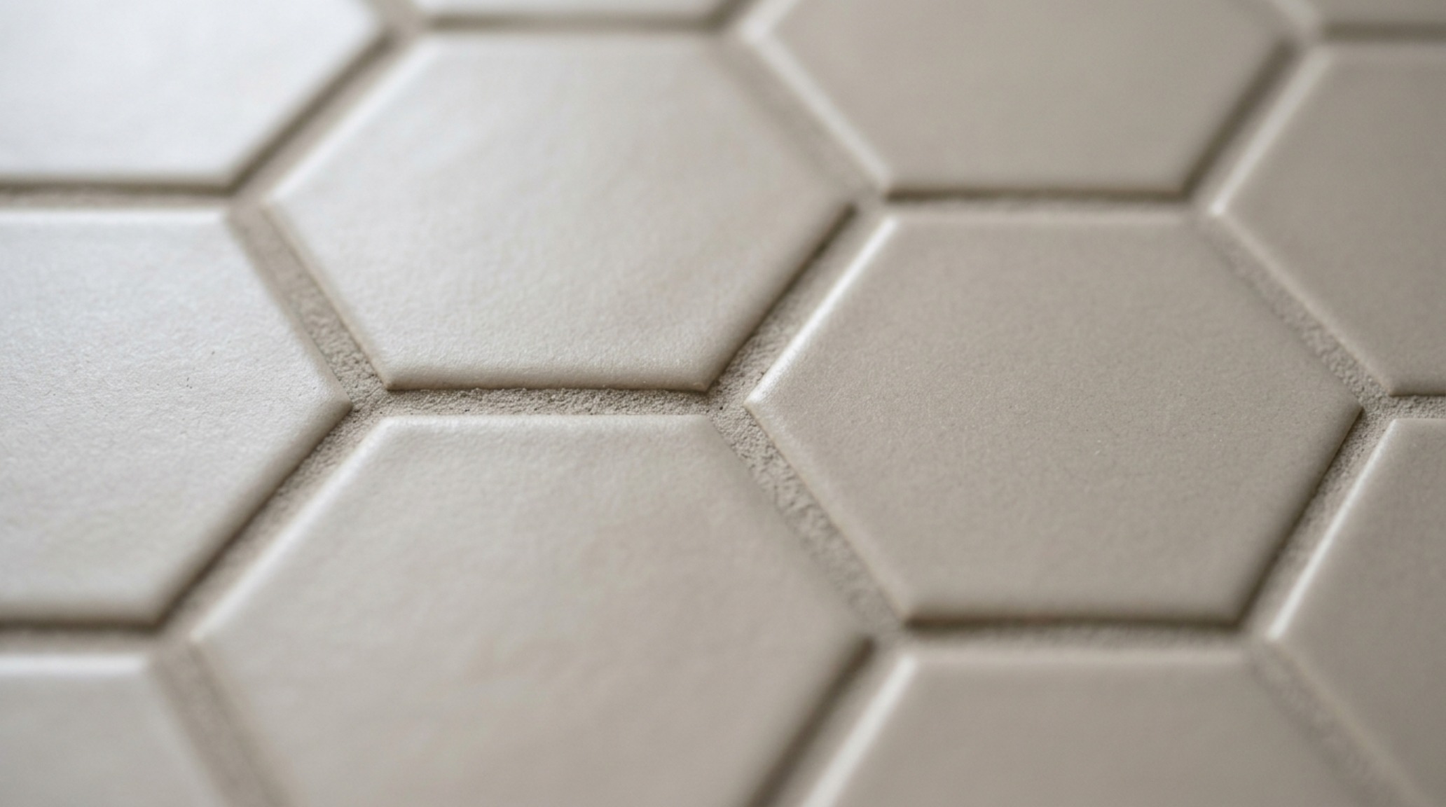 Grout color coordination guide illustrated by a close-up of geometric backsplash tiles with perfectly matched epoxy grout for a subtle, unified surface appearance. Grout color coordination guide illustrated by a close-up of geometric backsplash tiles with perfectly matched epoxy grout for a subtle, unified surface appearance.