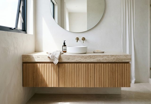 floating vanity storage solutions crafted in fluted white oak with integrated UV-C sanitizing drawers and a honed travertine countertop