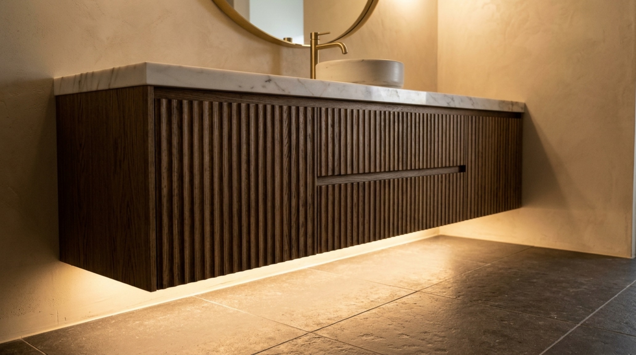 Minimalist vanity lighting with recessed LED channels providing a soft glow to a fluted wood vanity and vessel sink. Minimalist vanity lighting with recessed LED channels providing a soft glow to a fluted wood vanity and vessel sink.