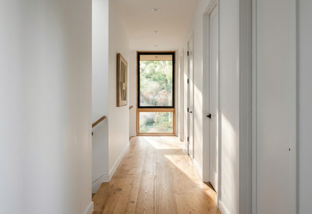 modern house layout ideas featuring a wide 42-inch hallway with white oak flooring and terminal vista natural light