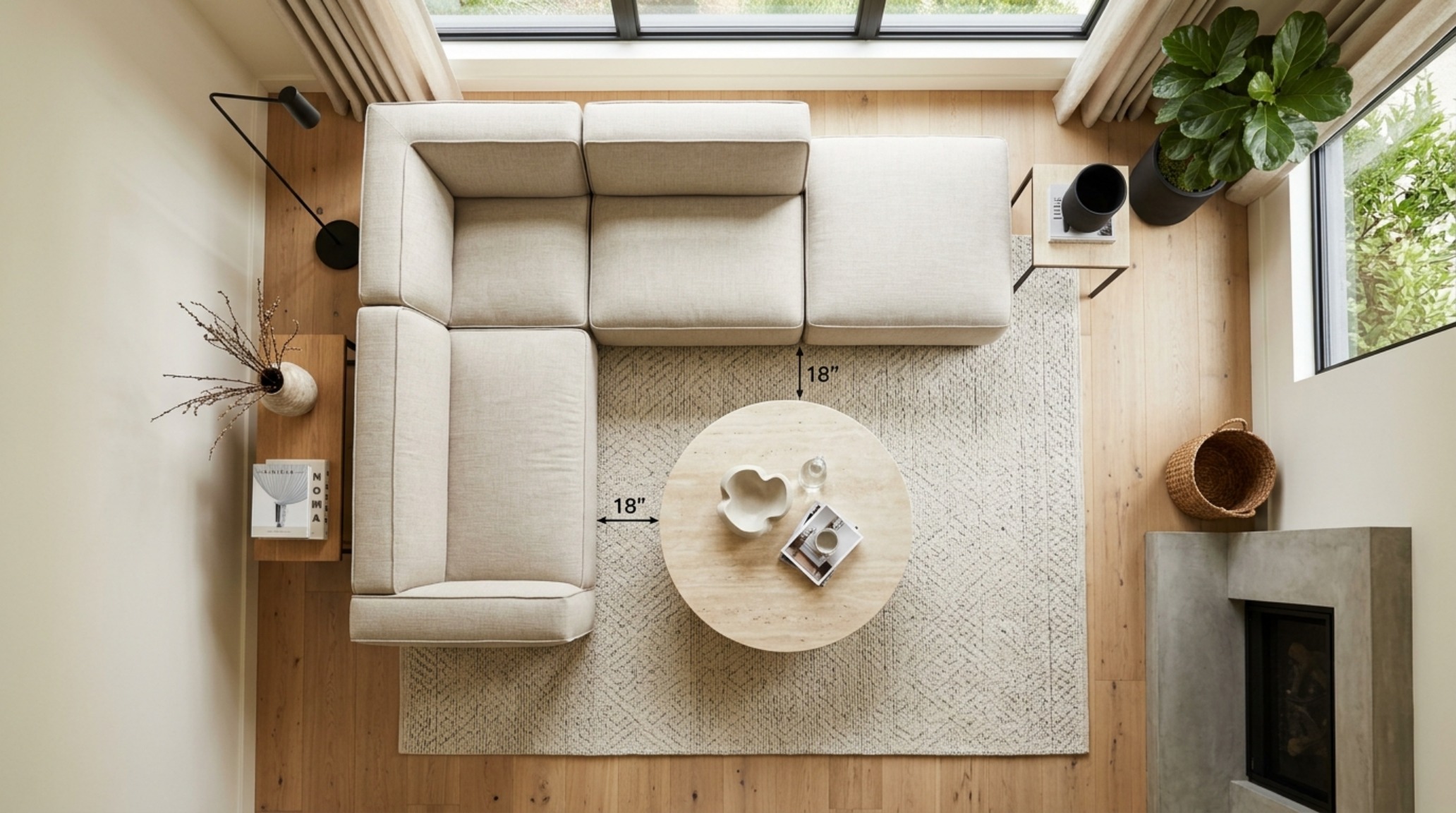 A luxury sectional layout showing 18-inch clearance between the sofa edge and a honed travertine coffee table in a modern apartment.