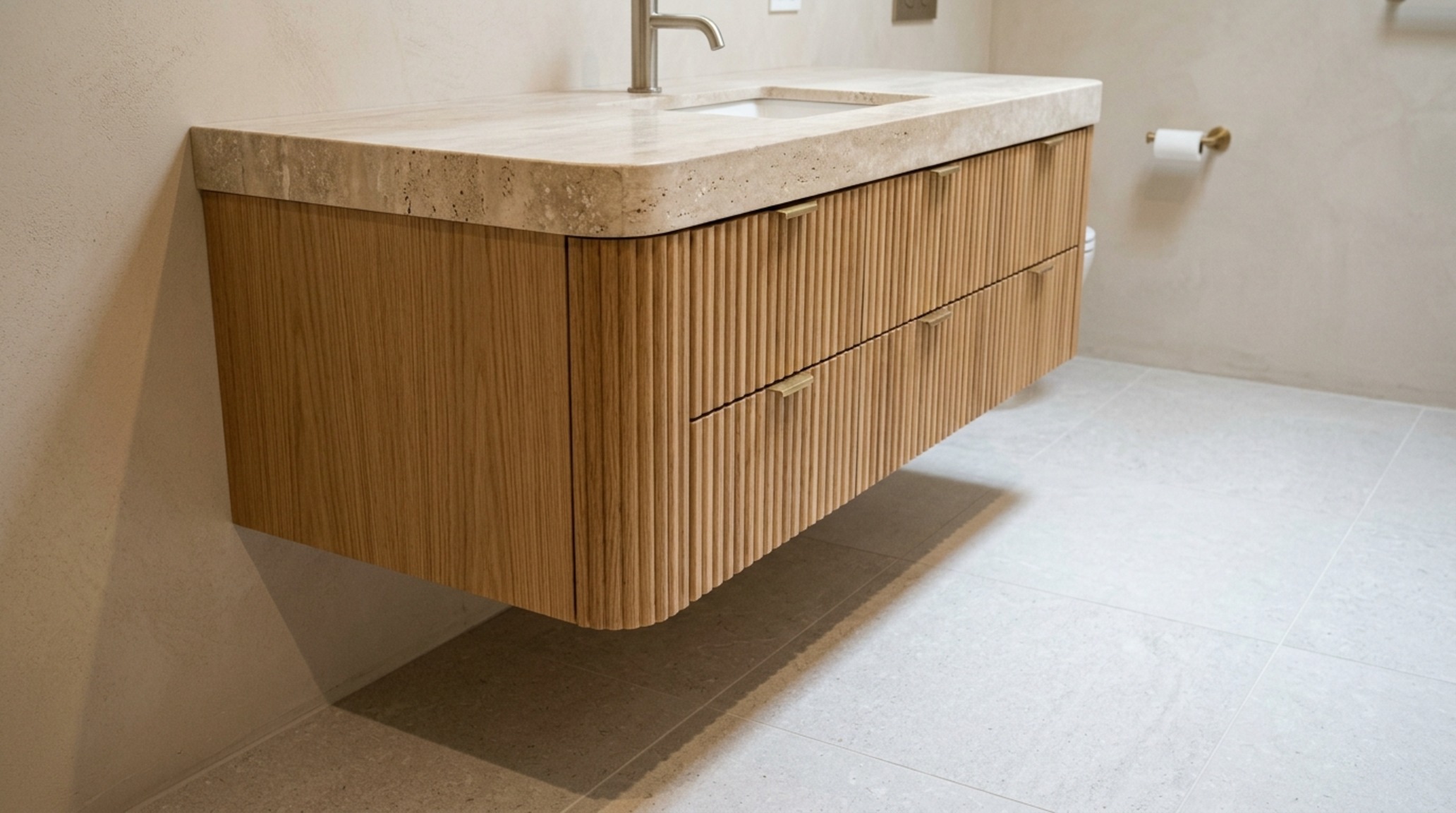 Interior design clearance standards for a bathroom featuring a floating white oak vanity with 12-inch toe-kick clearance and honed marble floors.