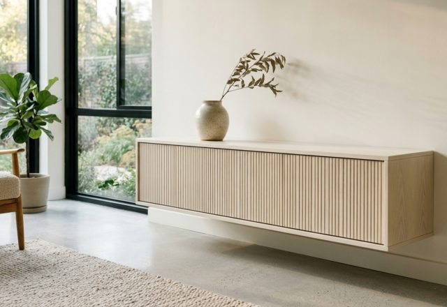 A wall-mounted floating Bestå media console finished in Benjamin Moore Swiss Coffee with a custom fluted oak top, exemplifying ikea storage hacks decor ideas in a minimal living room.
