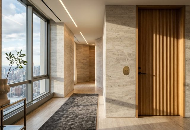 private elevator apartment floor plans featuring a minimalist stone vestibule with recessed warm 2700K lighting and fluted timber wall panels.