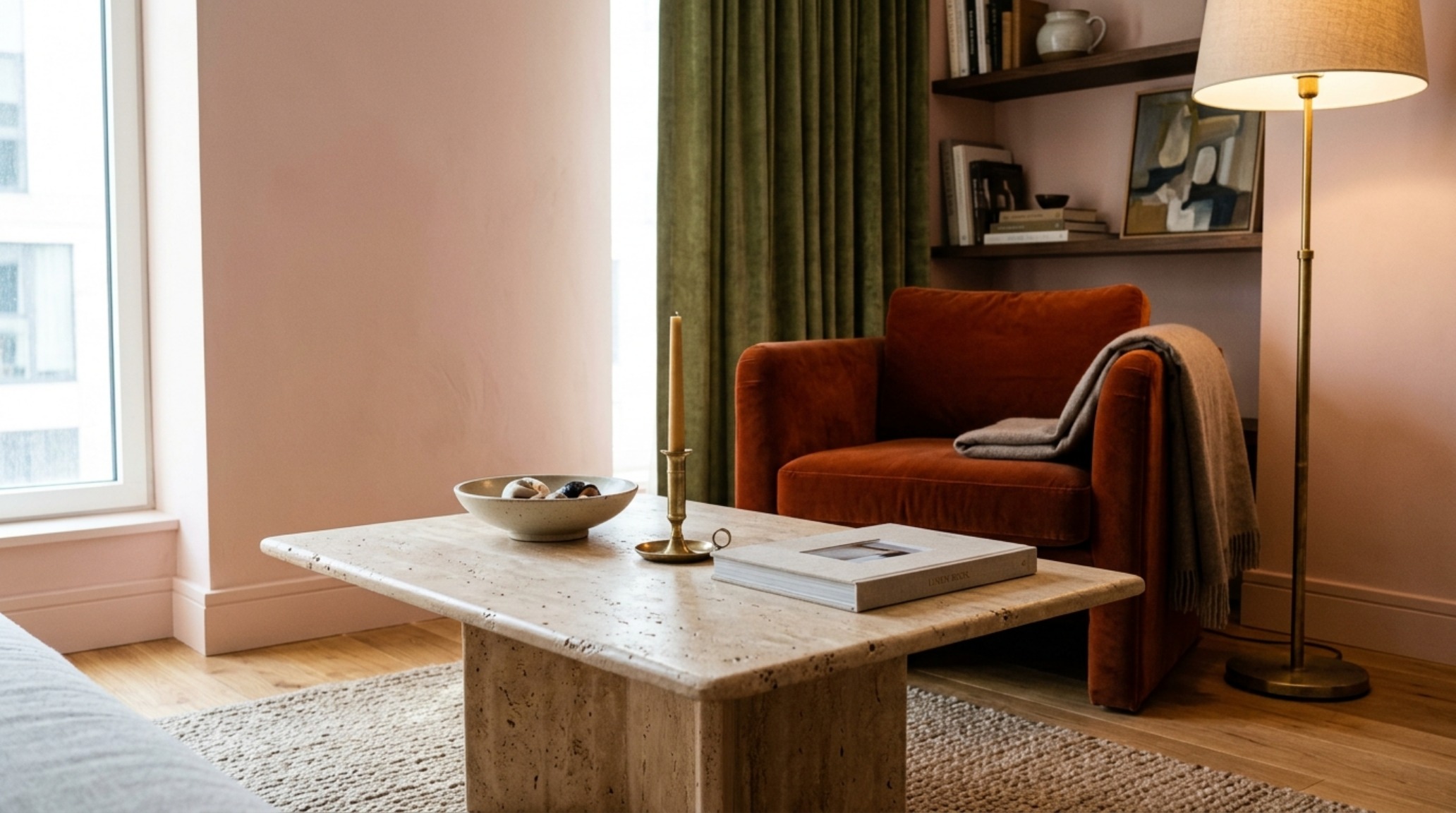Luxury aesthetic for compact living shown through honed travertine coffee tables, high-CRI lighting, and a neutral palette of Farrow & Ball Setting Plaster.
