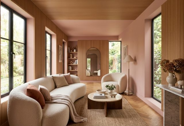 long narrow living room layout featuring a color-drenched palette in Farrow & Ball Setting Plaster with a curved velvet sofa and fluted oak cabinetry