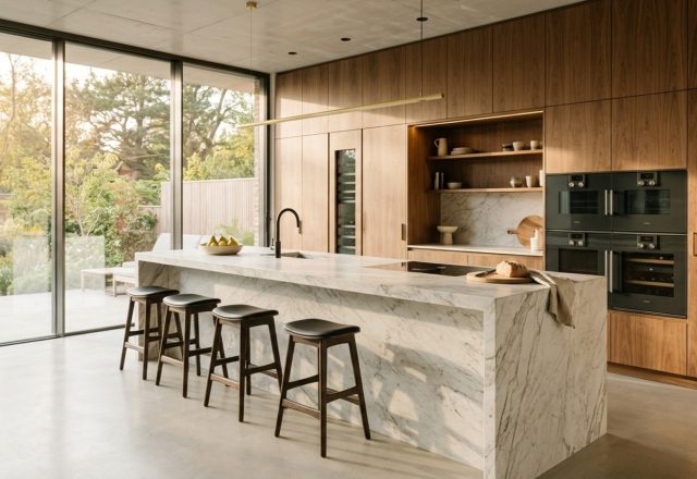 Minimalist kitchen layout ideas showcasing a seamless walnut cabinet wall and a parallel 48-inch deep stone island.