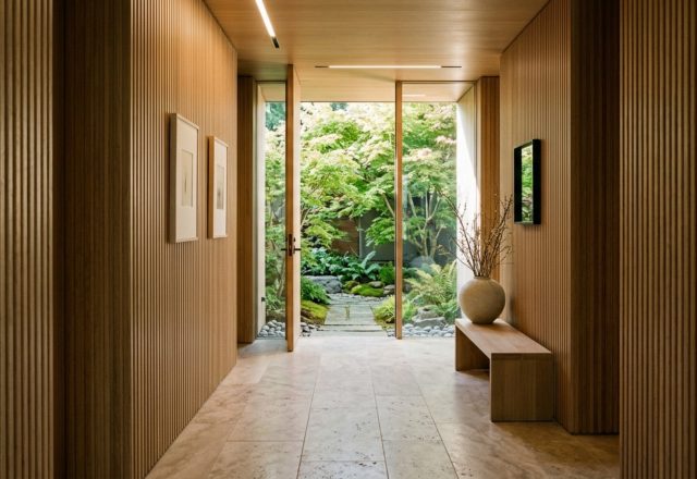 spatial planning for interiors featuring a minimal foyer with a 48-inch wide gallery hallway, fluted white oak paneling, and a direct sightline to a sun-drenched courtyard