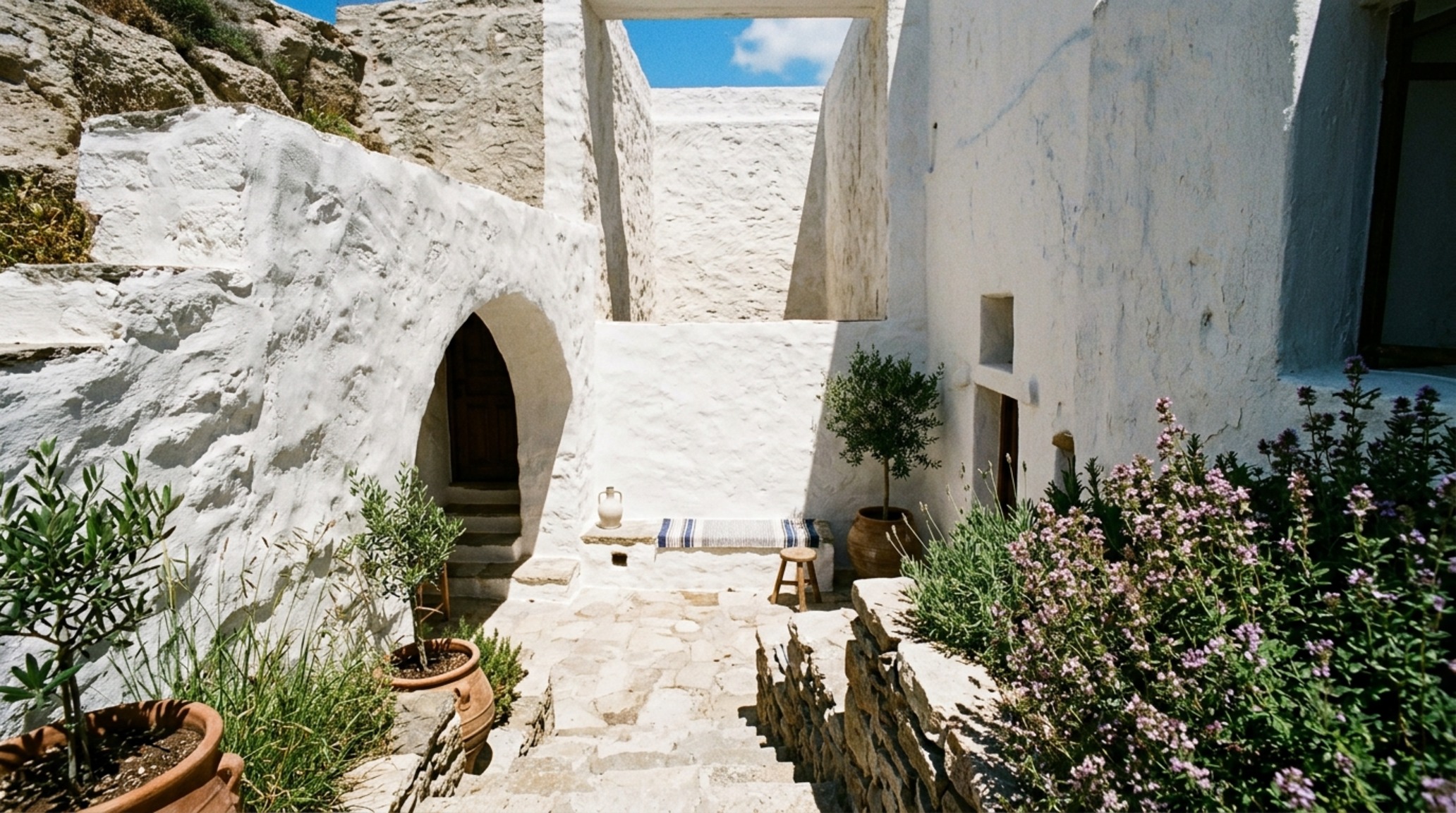 sustainable Greek island homes utilizing subterranean courtyards and vertical light wells to provide natural illumination and passive cooling in a desert-like landscape. sustainable Greek island homes utilizing subterranean courtyards and vertical light wells to provide natural illumination and passive cooling in a desert-like landscape.