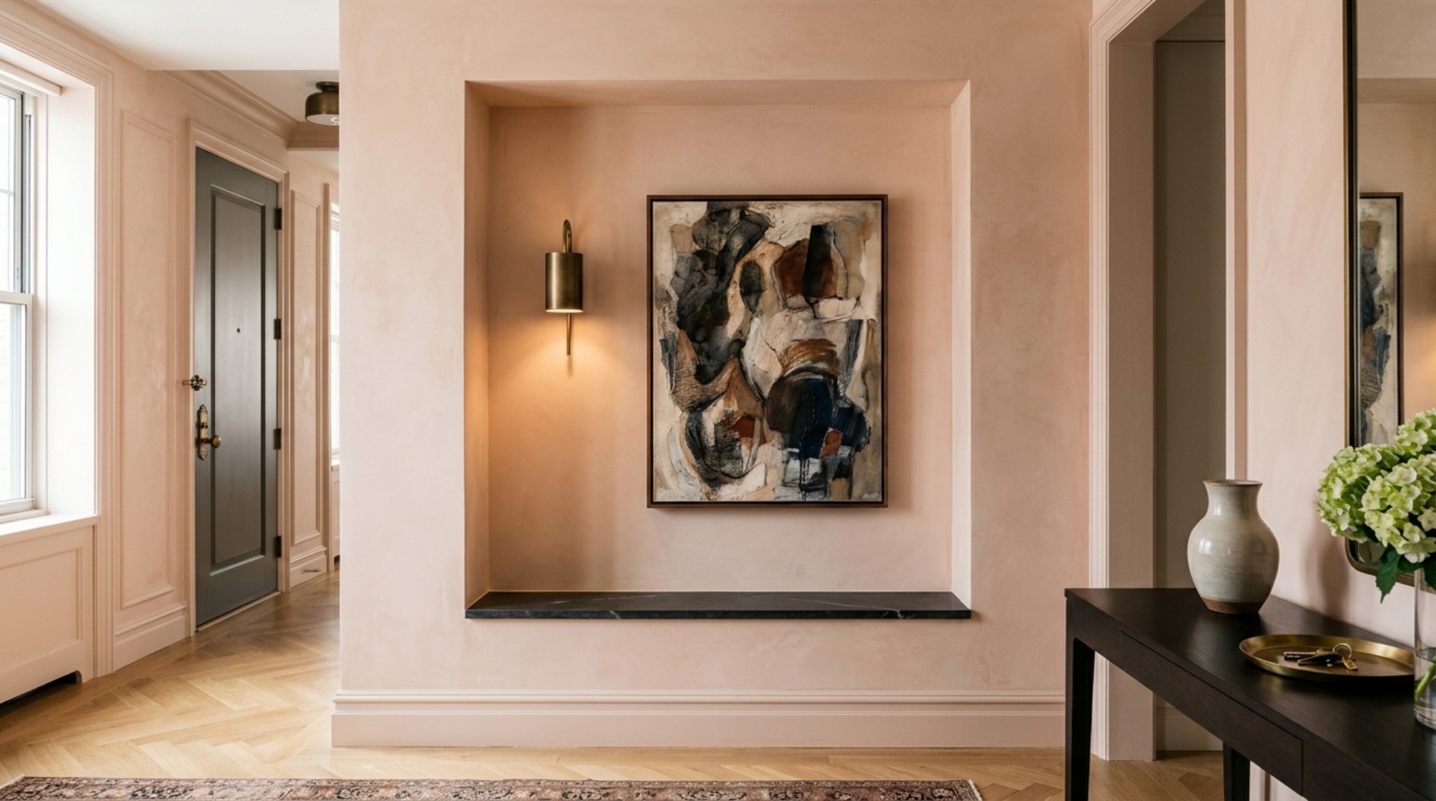 High-end entryway drop zone with 2700K warm ambient lighting and a marble console, reflecting Alexander Reid's transitional apartment style.