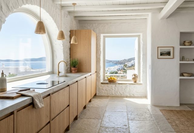 A wide-angle shot of a Mediterranean kitchen featuring Benjamin Moore Swiss Coffee walls and 36-inch walkway clearances, showcasing a modern antikythera island pay to live there decor idea for remote living.