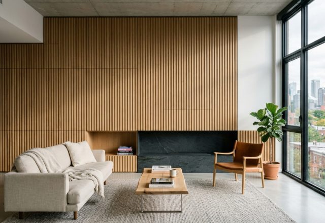 A minimalist living room featuring floor-to-ceiling white oak cabinetry and integrated shelving, epitomizing the best house apartment june 2017 decor ideas with a focus on seamless sightline alignment.