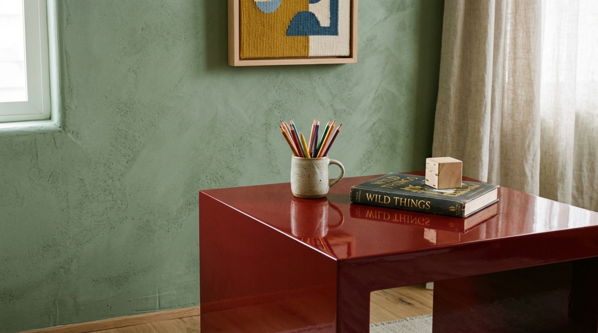 Close-up of a designer kids room corner showing the contrast between a high-gloss lacquered stool and a matte, pigmented lime-wash wall.