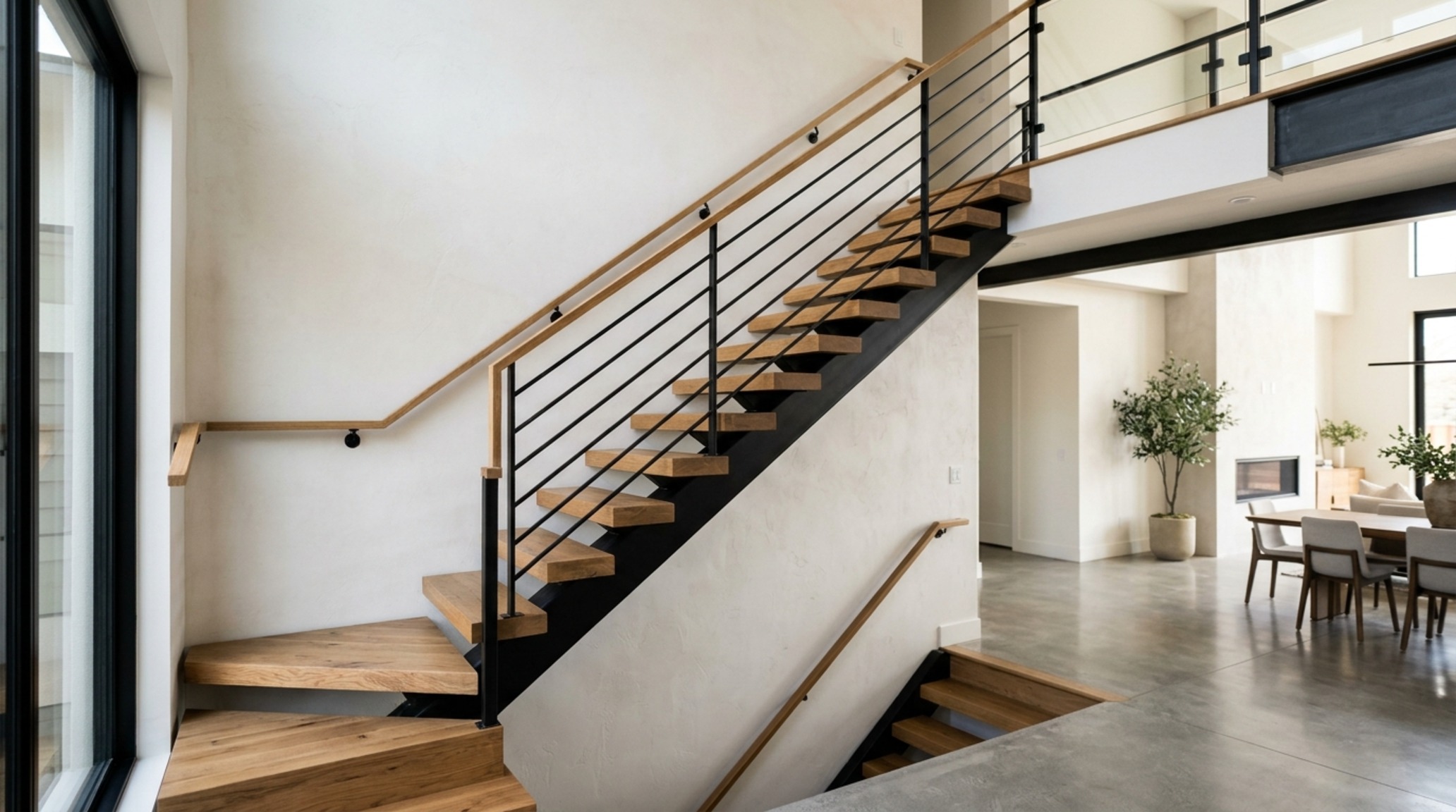 luxury open floor plan homes textures highlighting the contrast between a matte black steel staircase and warm wooden stair treads luxury open floor plan homes textures highlighting the contrast between a matte black steel staircase and warm wooden stair treads