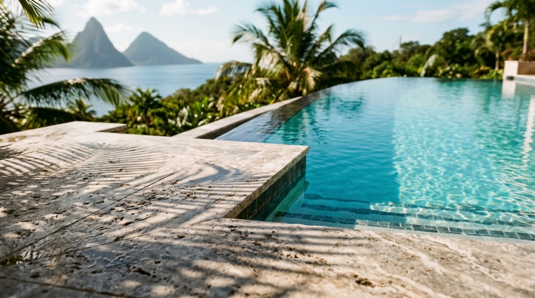 luxury st lucia infinity pool hotel textures featuring honed silver travertine pool coping meeting a matte volcanic stone wall under soft morning sunlight luxury st lucia infinity pool hotel textures featuring honed silver travertine pool coping meeting a matte volcanic stone wall under soft morning sunlight