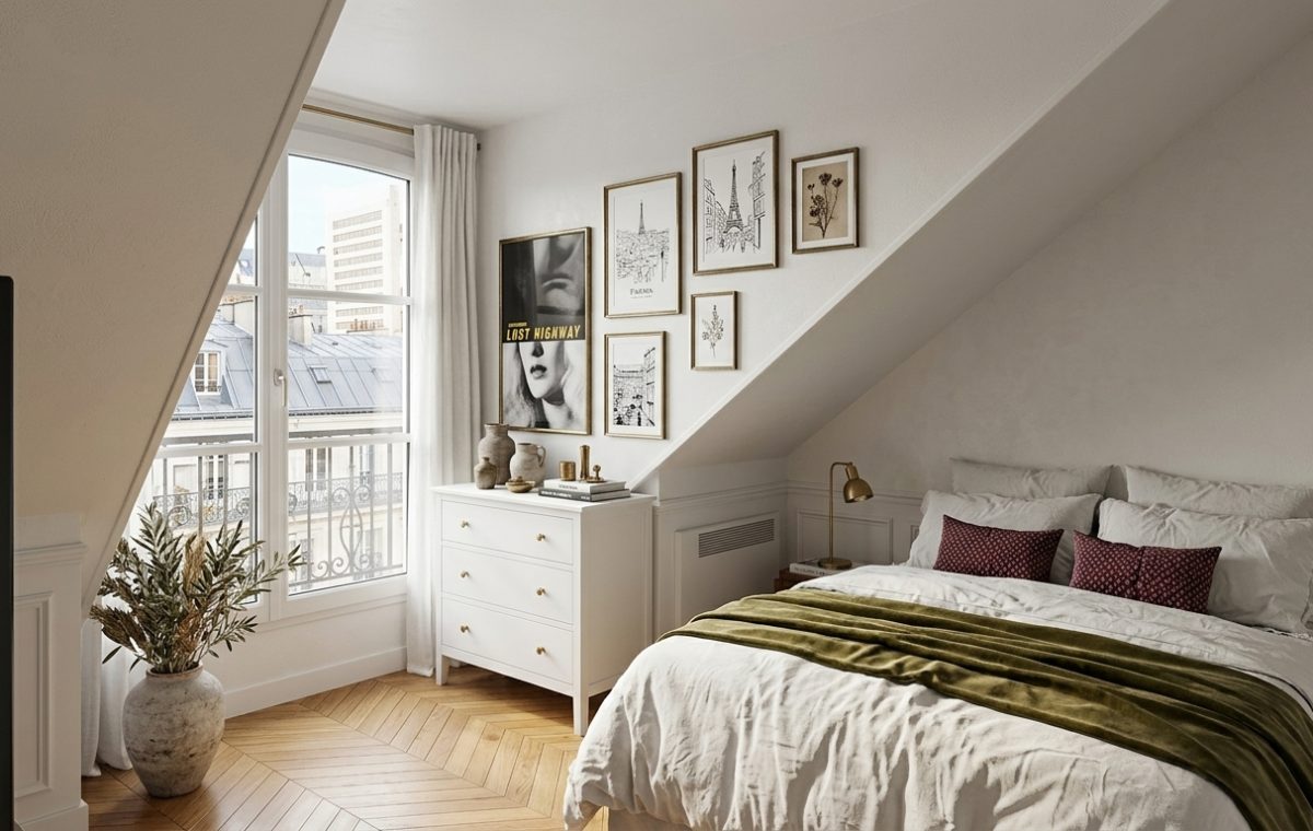 Cozy attic bedroom decor featuring slanted walls, a white dresser, and herringbone wood flooring overlooking a french balcony.