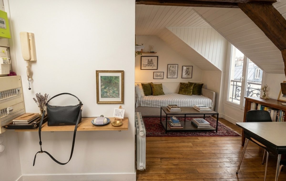 Cozy attic living room ideas featuring sloped ceilings, a daybed, and exposed wooden beams.