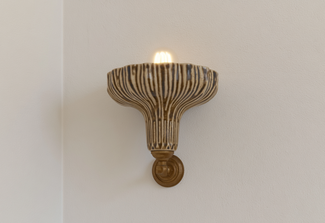 A ribbed ceramic wall sconce with a warm glowing bulb mounted on a neutral plaster wall.