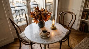 Small dining nook ideas featuring a round marble bistro table and cozy chairs in a Paris apartment.
