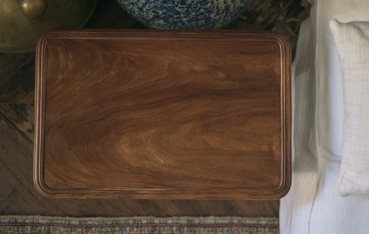 Overhead view of a classic wooden coffee table next to a white linen sofa.
